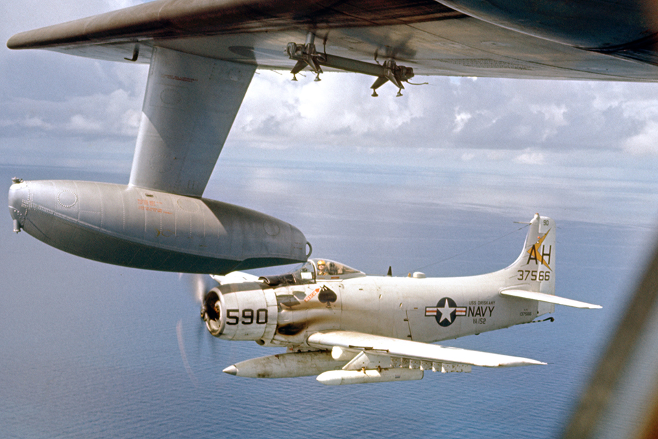 A Douglas A-1E escorts an Albatross off the Mekong Delta.